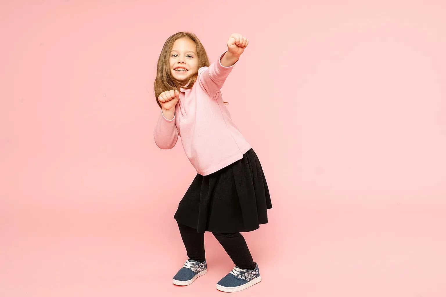 Girl in dynamic dance pose — Grades 1-2 class